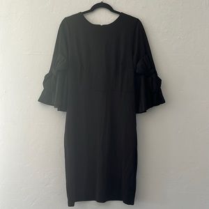 Plus size women’s Eloquii black dress with bow sleeve detail